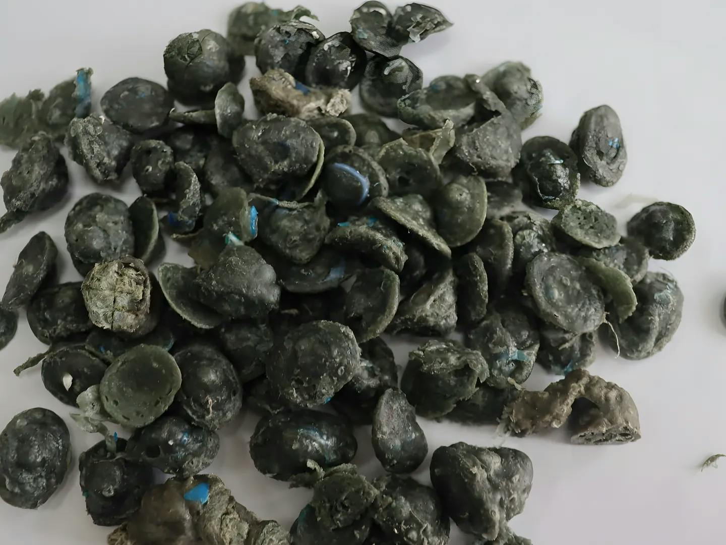 Various plastic products like pipes and pallets made from recycled pellets.
